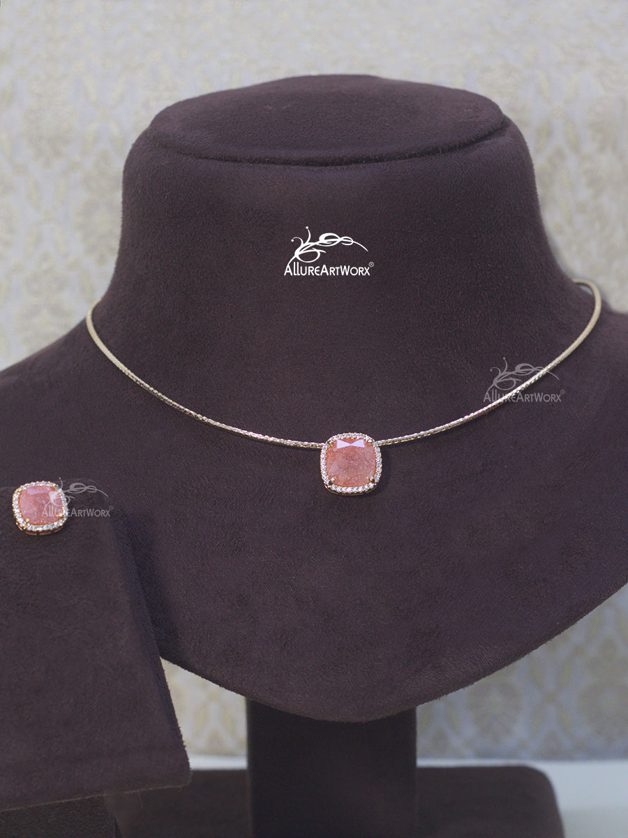 Necklace with pink gemstones on a mannequin bust with Allure Artworx branding.